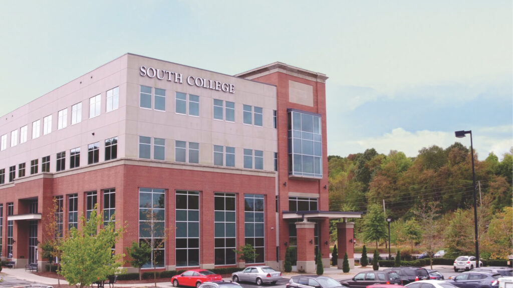 A multi-story brick and glass building with the sign "SOUTH COLLEGE" prominently displayed at the top.